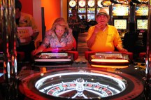fl-roulette-laws-gamblingB - Yolanda Febles, left, and Abundio Febles play the new Roulette slot machine table at Magic City Casino in Miami, Florida on Monday, April 23, 2012. Sarah Dussault, Sun Sentinel