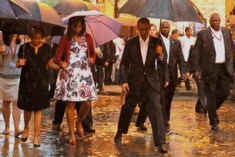 U.S. President Barack Obama steps over a puddle while touring Old Havana with his family, in Havana March 20, 2016. REUTERS/Carlos Barria - RTSBDLD